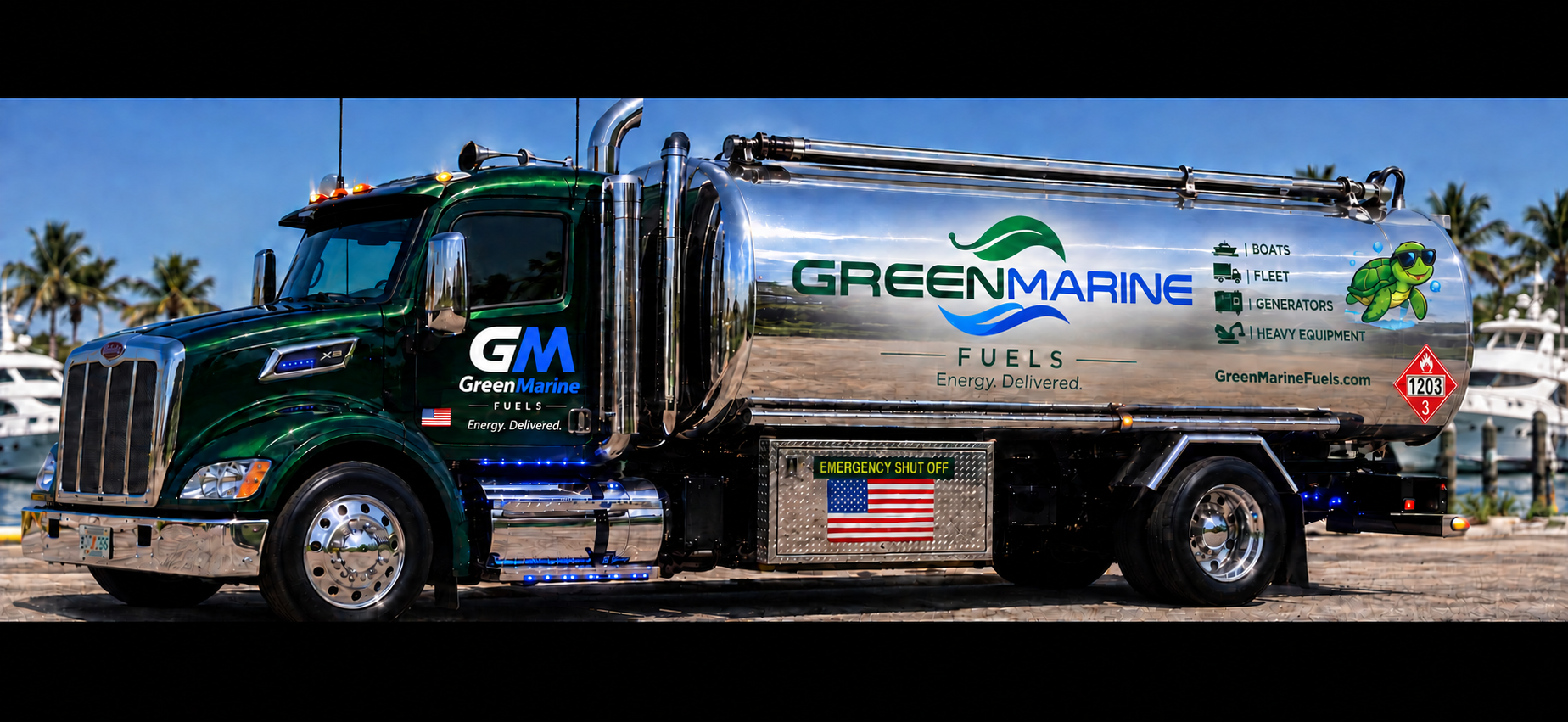 Emerald GreenMarine Fuels tanker with revised geometric white-and-blue GM cab lettering, green leaf and blue wave branding, and turtle mascot at a South Florida marina